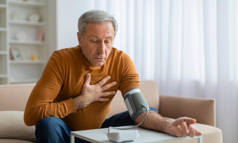 Primary care physician checking blood pressure of an adult patient during a hypertension evaluation in Richmond TX